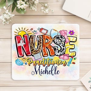 May include: A rectangular mousepad with the word "NURSE" in large, colorful letters, with the word "Practitioner" and a name below. The design includes medical symbols and a sun. A laptop and notepad are in the background.