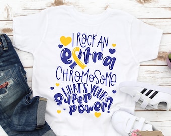 May include: White t-shirt with a blue and yellow design that says "I rock an extra chromosome what's your superpower?"