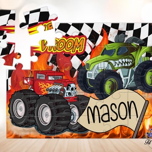 May include: A jigsaw puzzle featuring two monster trucks, one red and one green, set against a background of flames and a checkered flag. The text VROOM appears in yellow, and a beige flag in the foreground displays the name mason in black text.