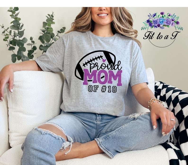 A gray t-shirt with a football graphic and the words "proud MOM".  May be customized with your favorite player's number.