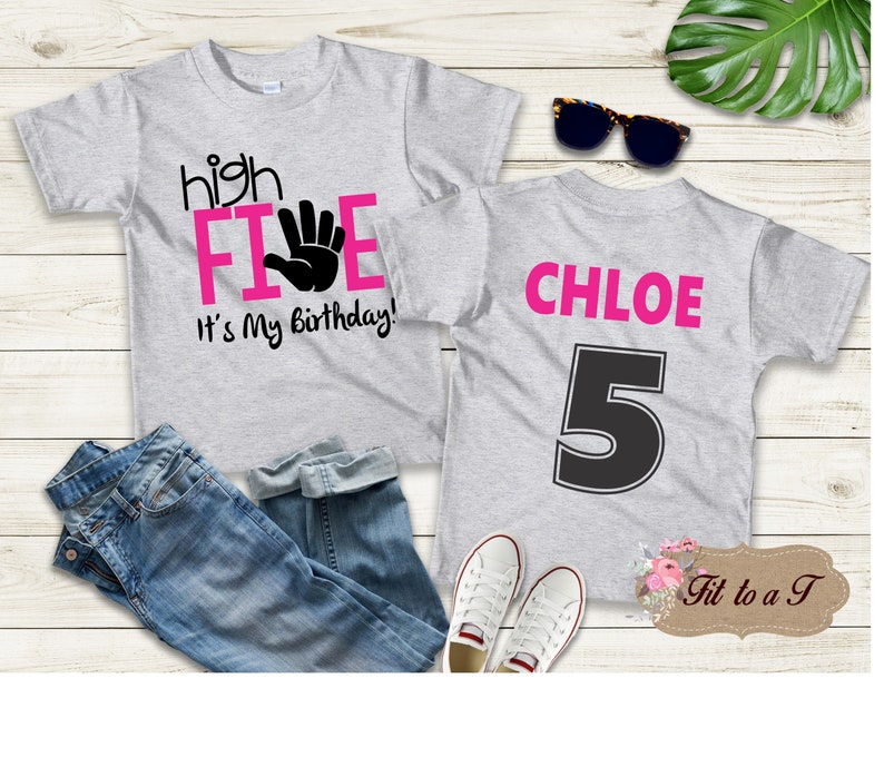 May include: Two gray t-shirts with pink and black text. The front shirt says "high FIVE" with a pink handprint and "It's My Birthday!" The back shirt says "CHLOE" in pink and has a black number "5" on it.
