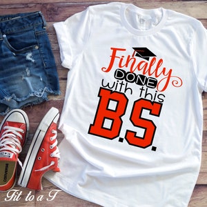 May include: White t-shirt with red and black text that says "Finally done with this BS."  The text is in a playful, handwritten font.  The shirt is being modeled with denim shorts and red sneakers.