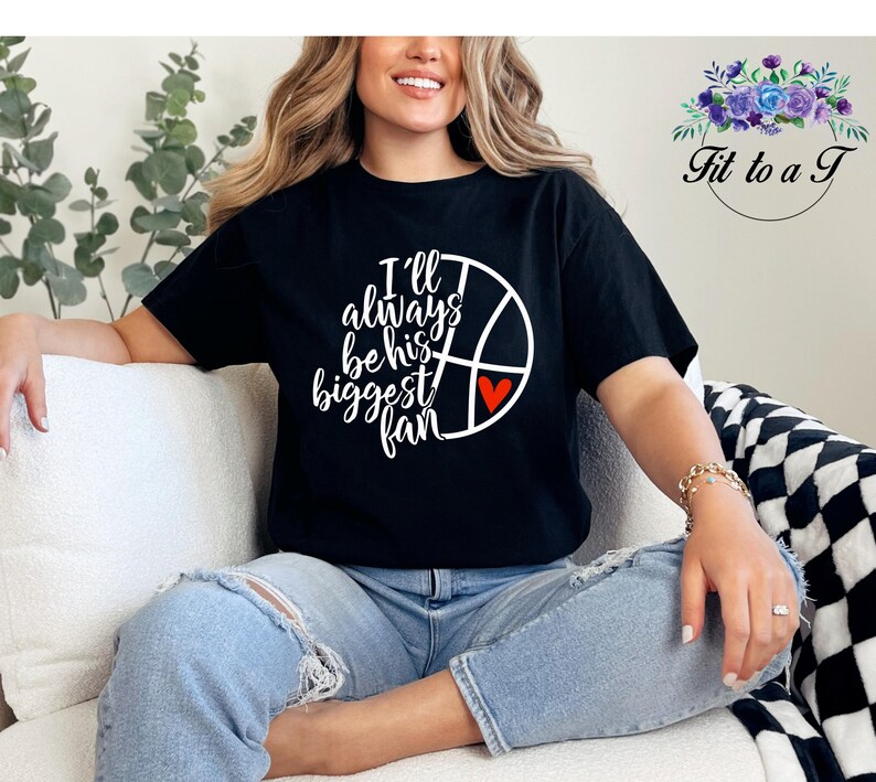 Gildan unisex basketball mom T-shirt featuring a basketball and heart graphic with the message “I’ll always be his biggest fan.”