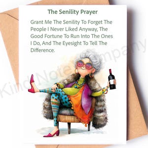 May include: Greeting card with the text "The Senility Prayer" and a humorous illustration of a woman holding a wine bottle. The woman is wearing colorful clothing and sunglasses. The card is on a brown envelope.