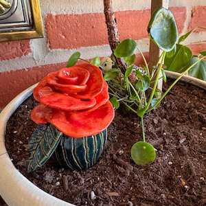 May include: A white ceramic mug with a black handle and the text "But First, Coffee" in a black, bold font. The mug is on a white surface. The mug is 4 inches tall.
