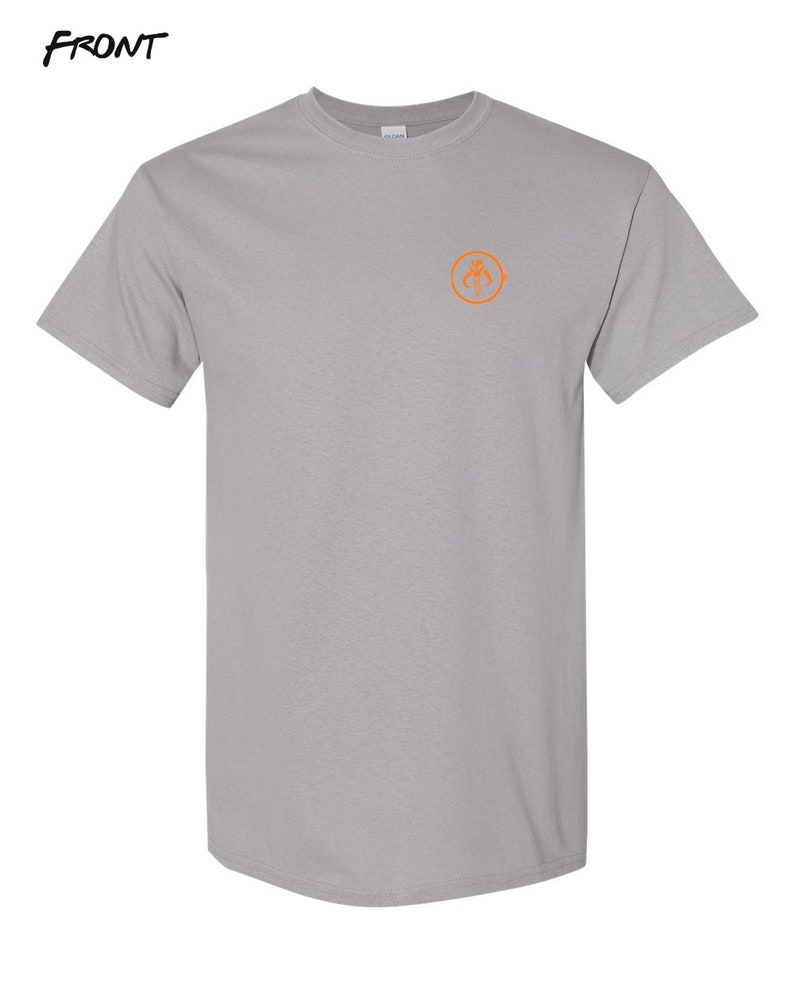 May include: A gray t-shirt with a small orange circle on the front. The circle contains a stylized graphic of a spider.