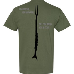 May include: A green t-shirt with a black silhouette of a rifle and the text "I can bring you in warm, or I can bring you in cold".