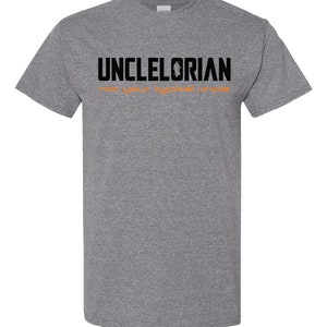 Puede incluir: Una camiseta gris jaspeada con texto negro que dice "Unclelorian Not Your Typical Uncle".