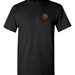 May include: Black t-shirt with an orange Mandalorian symbol on the front.
