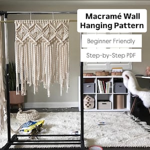 Handmade macramé wall hanging pattern featuring repeating diamond shapes, square knots, and long fringe. Beginner-friendly boho wall art tutorial using natural cotton cord. Shown in a room with a white rug, desk and bookshelf. Great for above a bed or office.