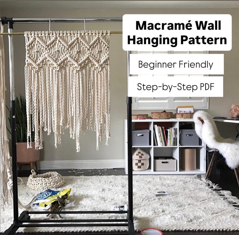 Handmade macramé wall hanging pattern featuring repeating diamond shapes, square knots, and long fringe. Beginner-friendly boho wall art tutorial using natural cotton cord. Shown in a room with a white rug, desk and bookshelf. Great for above a bed or office.