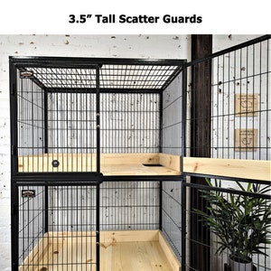 May include: Black metal pet cage with wire mesh sides and a wooden base. The cage has a sliding door and is 8.9 cm tall. The cage is designed for small animals and has a simple, functional design.