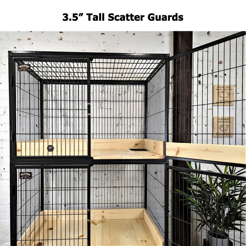May include: Black metal pet cage with wire mesh sides and a wooden base. The cage has a sliding door and is 8.9 cm tall. The cage is designed for small animals and has a simple, functional design.