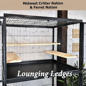 May include: A black metal animal cage featuring light-colored wooden lounging ledges installed inside. The cage has a wire grid structure with a solid black base tray. Text at the top reads Midwest Critter Nation & Ferret Nation.