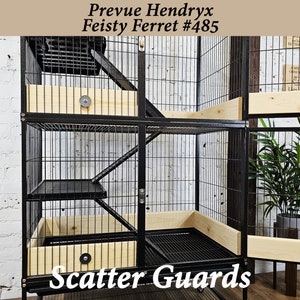 May include: Black metal multi-level ferret cage with wooden shelves and a ramp. The cage has a sign that reads "Prevue Hendryx Feisty Ferret #485" and "Scatter Guards".