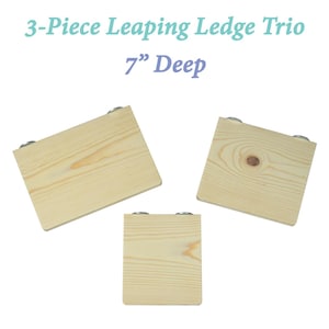 May include: Three wooden shelves, each with a 7 inch depth, designed for small animals to jump between. The shelves are made of natural wood and have a light brown color. Each shelf has two metal brackets for mounting.