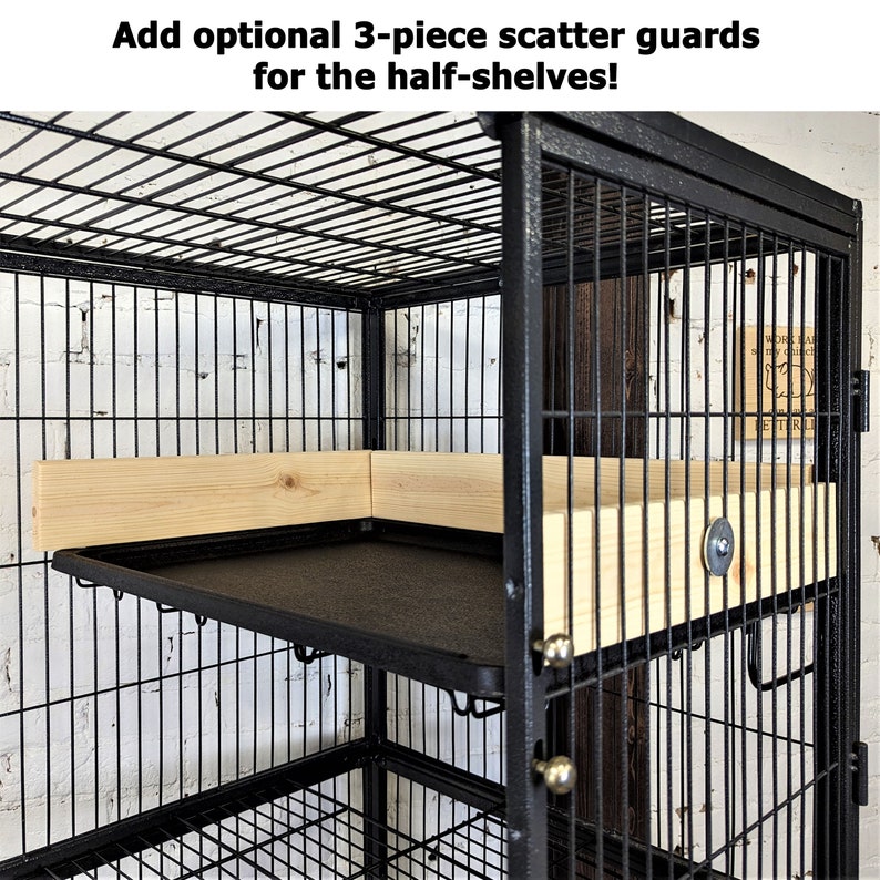 May include: A black metal cage with a rectangular shape, featuring a black tray and wooden shelves. The text at the top says, "Add optional 3-piece scatter guards for the half-shelves!"