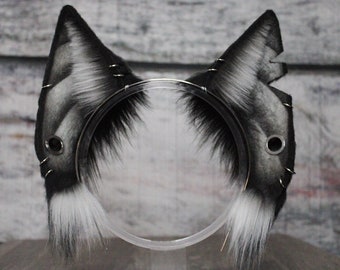 May include: Black and white cat ears headband with a silver metal hoop and rivets. The ears are made of faux fur and have a realistic cat ear shape.