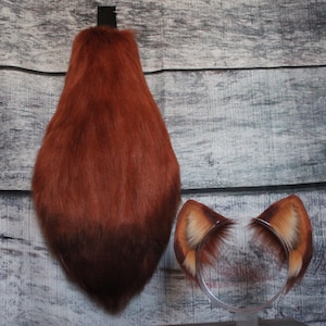 May include: A set of fox costume accessories, including a fluffy brown tail and a headband with two brown fur ears.