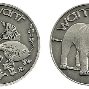 May include: Two silver-toned coins with opposite messages. One coin features a goldfish with the text "I don't want". The other coin features a bulldog with the text "I want".