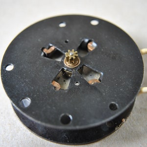 Electric clock motor top