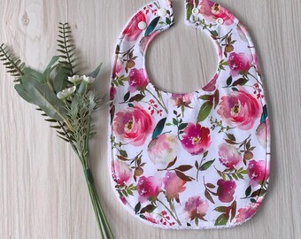 Floral patterned bib with double snaps and towelling
