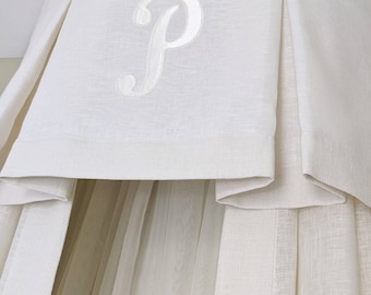 Linen crown canopy with a monogram.