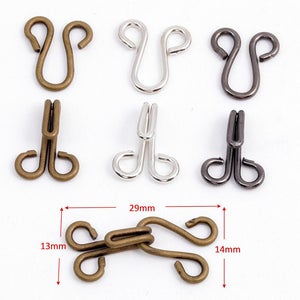 May include: Assortment of metal hook and eye closures in antique brass, silver, and black finishes. The hooks and eyes are available in two sizes: 13mm x 14mm and 29mm.