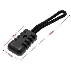 May include: Black plastic zipper pull with a textured design. The pull is attached to a black cord that is 63 mm long. The pull is 24 mm long and 15 mm wide.