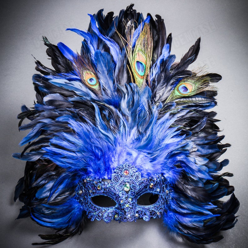 May include: A blue and black masquerade mask with peacock feathers. The mask is decorated with rhinestones and sequins.