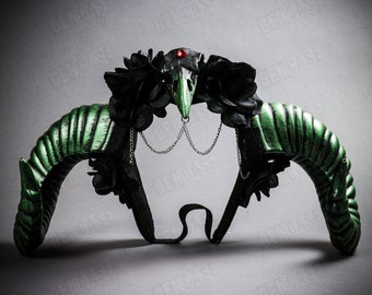 May include: Green and black horned headband with a black skull and red jewel in the center. The headband is decorated with black fabric roses and a silver chain.