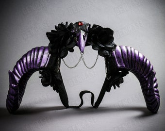 May include: Purple devil horns headband with black flowers and a skull with a red jewel in the eye socket. The headband has a chain detail.