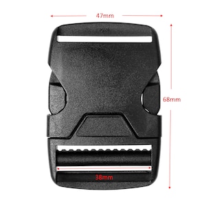 May include: Black plastic buckle with a 47mm width, 68mm height, and 38mm depth. The buckle has a textured surface and a smooth, flat top.