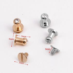 May include: Four metal knobs with clear rhinestones. Two knobs are gold with a 7 mm diameter and 5 mm height. The other two knobs are silver with a 7 mm diameter and 5 mm height. A gold screw with a 7 mm diameter is also included.