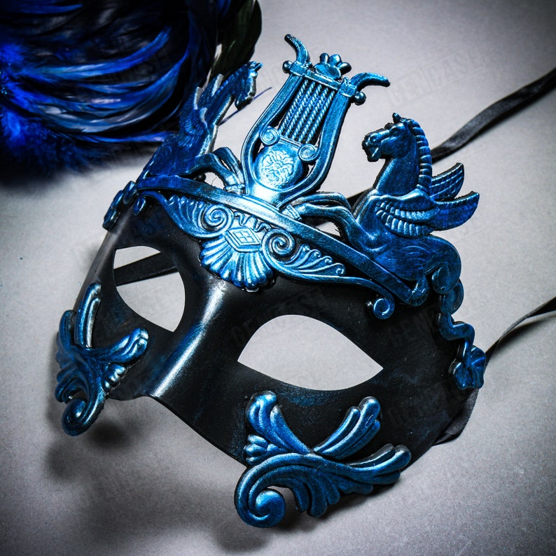 May include: A black masquerade mask with blue accents. The mask features a lyre, a winged horse, and intricate floral designs.