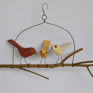 Three hand carved folk bird branch swing