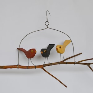 Three hand carved folk bird branch swing