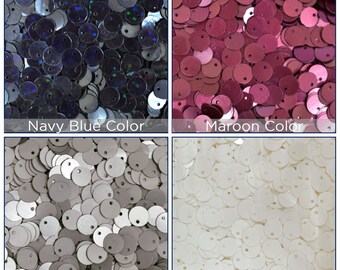 Puede incluir: Surtido de lentejuelas redondas en cuatro colores: azul marino, granate, beige tapicería y blanco. Las lentejuelas son todas del mismo tamaño y tienen un acabado brillante.