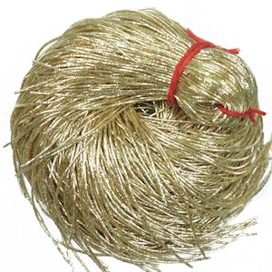 May include: A large spool of gold metallic cord. The cord is tightly wound and has a shiny, metallic finish.