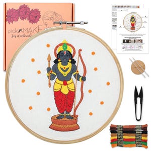 May include: Embroidery kit featuring a detailed embroidered image of a deity with a bow and arrow, in a wooden hoop. The kit includes thread, instructions, and a box with the text "pick n MAKE Joy of embroidery".