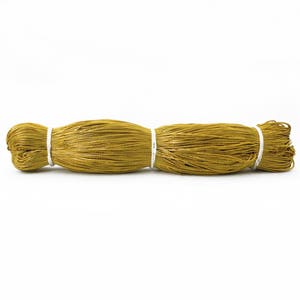 May include: A spool of gold metallic cord, tied with white string.