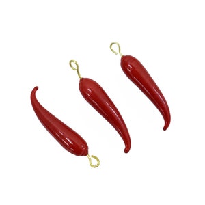 May include: Three red chili pepper charms with gold hooks. The chili peppers are a bright red color and have a glossy finish.