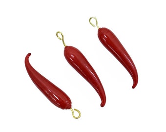 May include: Three red chili pepper charms with gold hooks. The chili peppers are a bright red color and have a glossy finish.