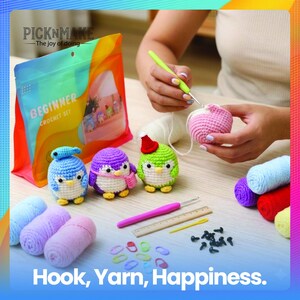 May include: A beginner crochet set with colorful yarn, crochet hooks, and small penguin-shaped amigurumi. The image includes the text "Hook, Yarn, Happiness" and the brand name "PICKNMAKE".