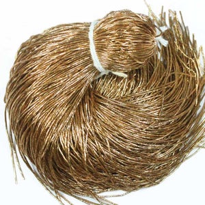 May include: A large spool of gold metallic thread. The thread is very fine and is ideal for crafting and jewellery making.