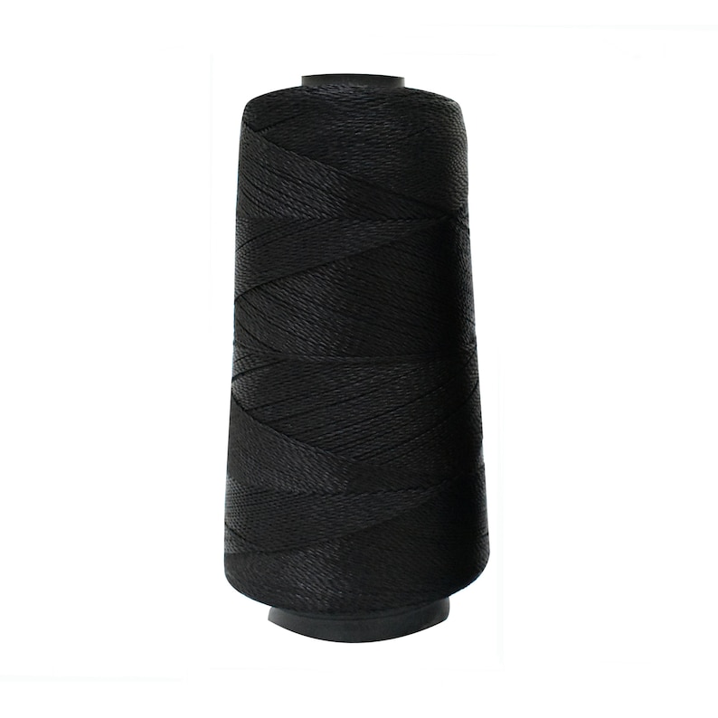May include: A spool of black thread.