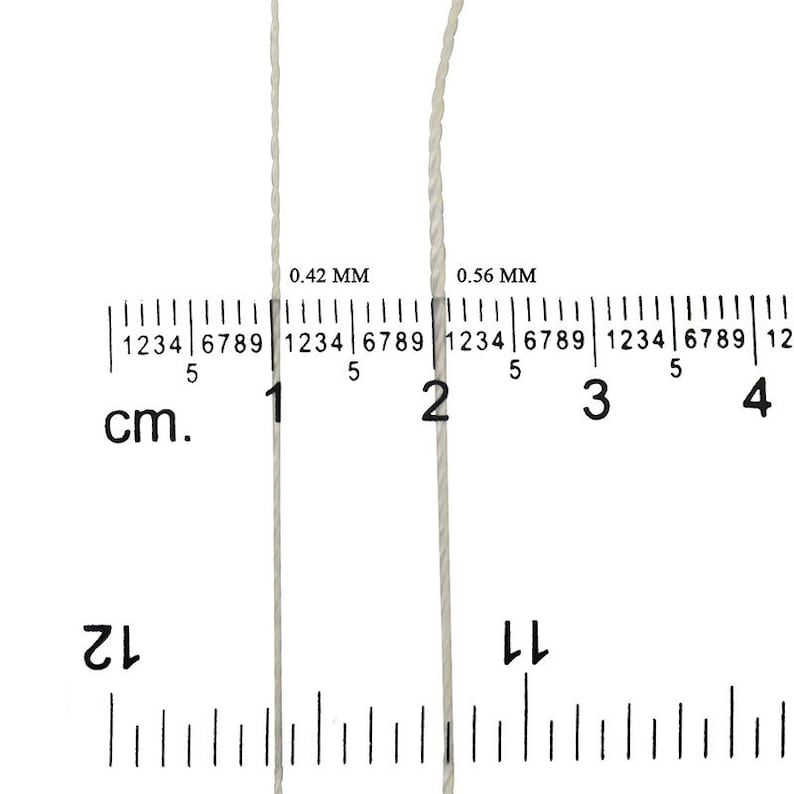 May include: Two white cords are shown against a white background with a ruler measuring in centimeters. The cord on the left is 0.42 mm thick and the cord on the right is 0.56 mm thick.