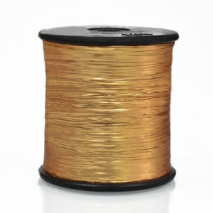 May include: A spool of gold metallic thread wound on a black plastic bobbin.