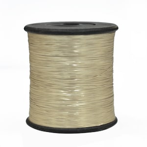 May include: A spool of beige thread wound around a black plastic bobbin.