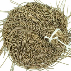 May include: A bundle of gold-colored wire, tied together with a white string. The wire is thin and flexible, and it is perfect for crafting jewelry or other projects.
